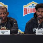 Colorado Buffaloes head coach Deion Sanders and quarterback Shedeur Sanders (2) talk with the media after the game against the Brigham Young Cougars at Alamodome.