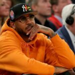 New York Knicks former player Carmelo Anthony sits courtside during the second half between the Villanova Wildcats and the Georgetown Hoyas at Madison Square Garden.