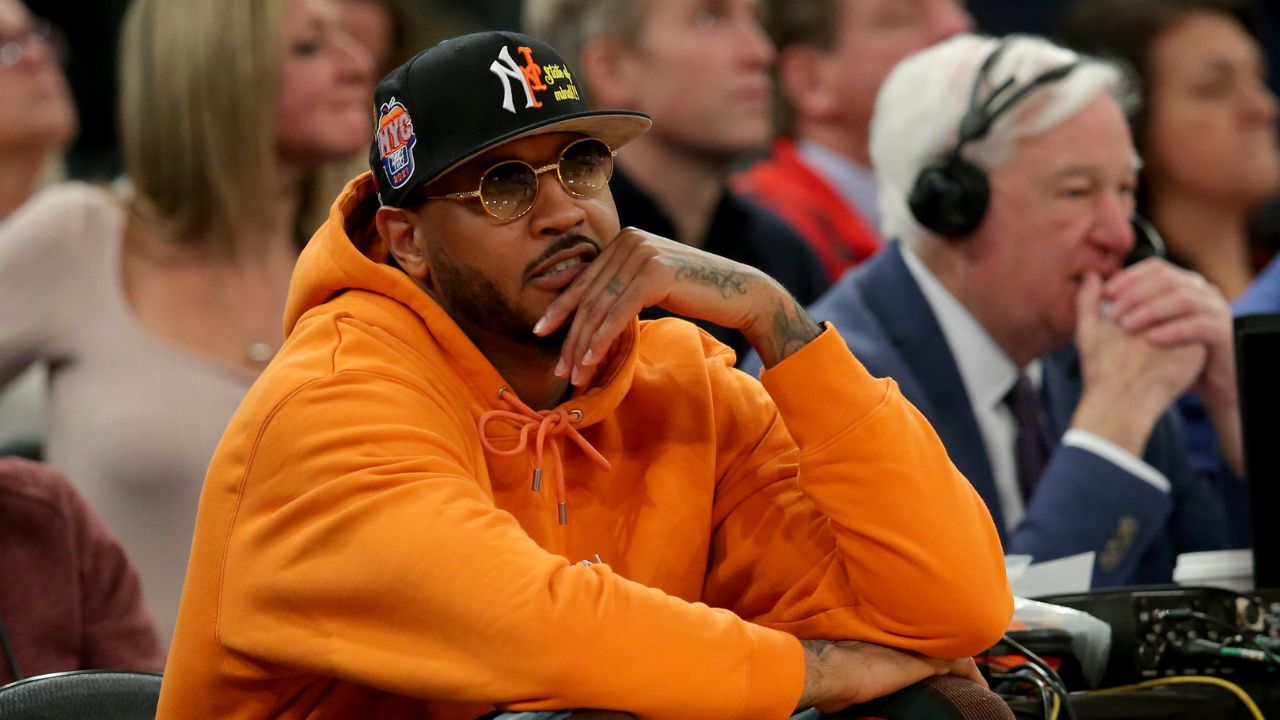 New York Knicks former player Carmelo Anthony sits courtside during the second half between the Villanova Wildcats and the Georgetown Hoyas at Madison Square Garden.