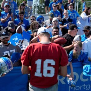 Detroit Lions quarterback Jared Goff signs items for fans after practice at the Lions practice facility in Allen Park on Saturday, July 27, 2024. This was the first time during this training camp that fans were allowed to watch practice and stay afterwards to see the players up close.