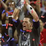 New England Patriots quarterback Tom Brady celebrates with the Vince Lombardi Trophy on the podium after defeating the Atlanta Falcons 34-28 in overtime in Super Bowl LI at NRG Stadium on Feb 5, 2017.