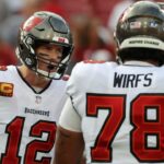 Tampa Bay Buccaneers quarterback Tom Brady (12) huddles up with offensive tackle Tristan Wirfs (78) against the Carolina Panthers prior to the game at Raymond James Stadium.