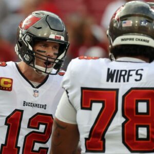 Tampa Bay Buccaneers quarterback Tom Brady (12) huddles up with offensive tackle Tristan Wirfs (78) against the Carolina Panthers prior to the game at Raymond James Stadium.