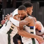 Milwaukee Bucks forward Giannis Antetokounmpo (34) and guard Damian Lillard (0) react after defeating the Atlanta Hawks at State Farm Arena.