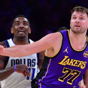 Los Angeles Lakers guard Luka Doncic (77) and Dallas Mavericks guard Kyrie Irving (11) attempt to gain control during the first quarter at Crypto.com Arena.