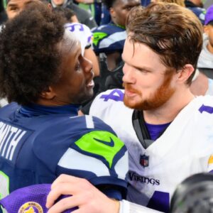 Dec 22, 2024; Seattle, Washington, USA; Seattle Seahawks quarterback Geno Smith (7) and Minnesota Vikings quarterback Sam Darnold (14) hug after the game at Lumen Field.
