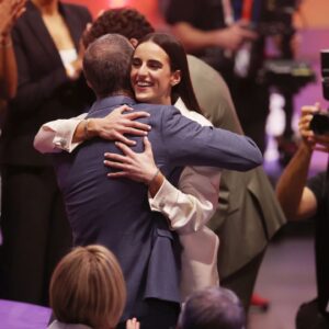 Caitlin Clark embraces her father Brent Clark after she is selected with the number one overall pick to the Indiana Fever in the 2024 WNBA Draft at Brooklyn Academy of Music.