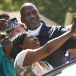 Michael Jordan takes a few photos with friends outside of The Michael Jordan Family Medical Clinic led by Novant Health. After taking part in a ribbon cutting ceremony for the new clinic opening off of Greenfield Street