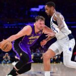 Los Angeles Lakers guard Luka Doncic (77) dribbles the ball against Dallas Mavericks forward P.J. Washington (25) during the second half at Crypto.com Arena.