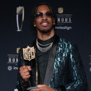 Washington Commanders quarterback Jayden Daniels poses with the Offensive Rookie of the Year award during Super Bowl LIX NFL Honors at Saenger Theatre. Mandatory