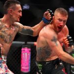 Max Holloway (blue gloves) fights Justin Gaethje (red gloves) during UFC 300 at T-Mobile Arena.