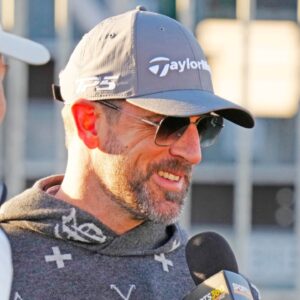 FeJets quarterback Aaron Rodgers talks with the press on the first tee box during the Phoenix Open Annexus Pro-Am at TPC Scottsdale.
