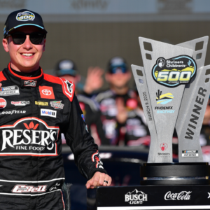 Mar 9, 2025; Avondale, Arizona, USA; NASCAR Cup Series driver Christopher Bell (20) celebrates his victory of the Shriners Children’s 500 at Phoenix Raceway. Mandatory Credit: Gary A. Vasquez-Imagn Images
