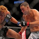 Nate Diaz (red gloves) fights Tony Ferguson (blue gloves) during UFC 279 at T-Mobile Arena.