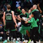 Boston Celtics forward Baylor Scheierman (55) reacts with the bench after hitting a three point shot during the second half at TD Garden.