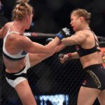 Ronda Rousey (red gloves) competes against Holly Holm (blue gloves) during UFC 193 at Etihad Stadium.