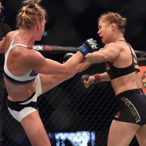 Ronda Rousey (red gloves) competes against Holly Holm (blue gloves) during UFC 193 at Etihad Stadium.