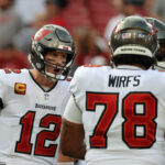 Tampa Bay Buccaneers quarterback Tom Brady (12) huddles up with offensive tackle Tristan Wirfs (78) against the Carolina Panthers prior to the game at Raymond James Stadium.