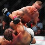 Justin Gaethje (red gloves) fights Rafael Fiziev (blue gloves) during UFC 313 at T-Mobile Arena.