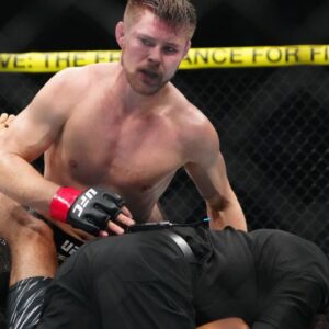 ; Bryce Mitchell (red gloves) reacts to defeating Kron Gracie (blues gloves) at T-Mobile Arena.