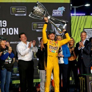 Nov 17, 2019; Homestead, FL, USA; NASCAR Cup Series driver Kyle Busch (18) celebrates winning the NASCAR Cup Series Championship after the Ford EcoBoost 400 at Homestead-Miami Speedway. Mandatory Credit: Peter Casey-Imagn Images