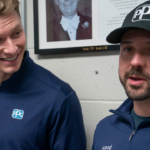 Two-time Indianapolis 500 winner Josef Newgarden, left, and NASCAR Cup Series driver Josh Berry get a copy of their eighth-grade class schedules in the office of Robert E. Ellis Middle School in Hendersonville, Tenn., Wednesday, Feb. 5, 2025. Both of the drivers are from Hendersonville and attended the school at the same time (although they didn't know each other).