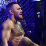 Conor McGregor reacts following an injury suffered against Dustin Poirier during UFC 264 at T-Mobile Arena.