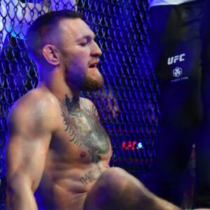 Conor McGregor reacts following an injury suffered against Dustin Poirier during UFC 264 at T-Mobile Arena.