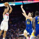Philadelphia 76ers guard Quentin Grimes (5) scores past Golden State Warriors guard Brandin Podziemski (2) during the second quarter at Wells Fargo Center