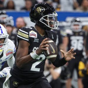Dec 28, 2024; San Antonio, TX, USA; Colorado Buffaloes quarterback Shedeur Sanders (2) runs with the ball as Brigham Young Cougars cornerback Evan Johnson (21) attempts to make a tackle during the third quarter at Alamodome.