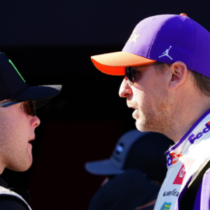 Feb 19, 2024; Daytona Beach, Florida, USA; NASCAR Cup Series driver Denny Hamlin (11) and driver Ty Gibbs (54) talk during driver introductions before the Daytona 500 at Daytona International Speedway. Mandatory Credit: John David Mercer-Imagn Images