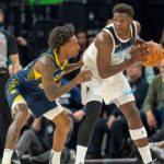 Mar 17, 2025; Minneapolis, Minnesota, USA; Minnesota Timberwolves guard Anthony Edwards (5) holds the ball as Indiana Pacers guard Quenton Jackson (29) plays defense in the second half at Target Center. Mandatory Credit: Jesse Johnson-Imagn Images