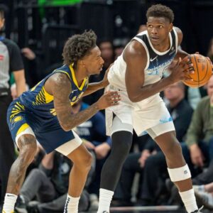 Mar 17, 2025; Minneapolis, Minnesota, USA; Minnesota Timberwolves guard Anthony Edwards (5) holds the ball as Indiana Pacers guard Quenton Jackson (29) plays defense in the second half at Target Center. Mandatory Credit: Jesse Johnson-Imagn Images