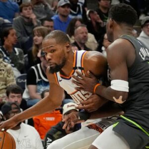 Phoenix Suns forward Kevin Durant (35) works around Minnesota Timberwolves guard Anthony Edwards (5) in the fourth quarter at Target Center.
