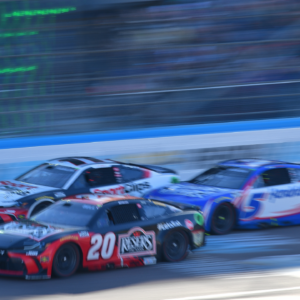 Mar 9, 2025; Avondale, Arizona, USA; NASCAR Cup Series driver Christopher Bell (20) crosses the finish line ahead of driver Denny Hamlin (11) and driver Kyle Larson (5) to win the Shriners Children’s 500 at Phoenix Raceway. Mandatory Credit: Gary A. Vasquez-Imagn Images
