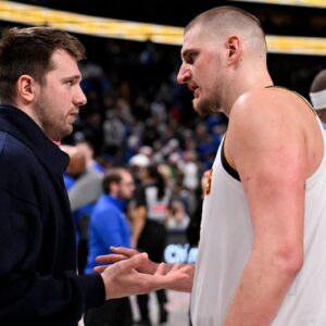 Dallas Mavericks guard Luka Doncic (left) talks with Denver Nuggets center Nikola Jokic (right) after the game at the American Airlines Center
