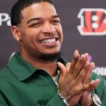 Cincinnati Bengals receiver Ja’marr Chase smiles as he takes questions during a press conference to announce the signing of new contracts for receivers Ja’Marr Chase and Tee Higgins at Paycor Stadium in downtown Cincinnati