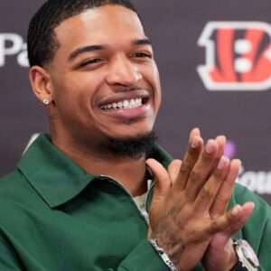 Cincinnati Bengals receiver Ja’marr Chase smiles as he takes questions during a press conference to announce the signing of new contracts for receivers Ja’Marr Chase and Tee Higgins at Paycor Stadium in downtown Cincinnati