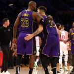 Los Angeles Lakers forward LeBron James (23) and guard Luka Doncic (77) react after a play during the fourth quarter against the LA Clippers at Crypto.com Arena.