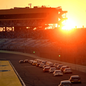 The sun sets as the field goes down the front stretch during the Ford Ecoboost 400 at Homestead-Miami Speedway.