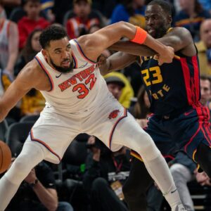 New York Knicks center Karl-Anthony Towns (32) controls the basketball against Golden State Warriors forward Draymond Green (23) during the third quarter at Chase Center.