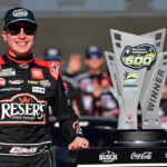 Mar 9, 2025; Avondale, Arizona, USA; NASCAR Cup Series driver Christopher Bell (20) celebrates his victory of the Shriners Children’s 500 at Phoenix Raceway. Mandatory Credit: Gary A. Vasquez-Imagn Images