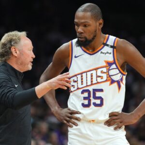 Phoenix Suns head coach Mike Budenholzer talks with Phoenix Suns forward Kevin Durant (35) against the Denver Nuggets during the second half at Footprint Center