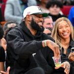 Los Angeles Laker LeBron James and his wife Savannah James sit court side at the McDonald's All American game during the first half at Toyota Center.