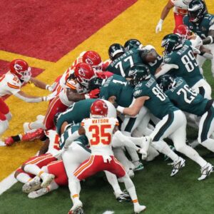 Philadelphia Eagles quarterback Jalen Hurts (1) rushes the ball for a touchdown against the Kansas City Chiefs during the first quarter in Super Bowl LIX at Caesars Superdome.