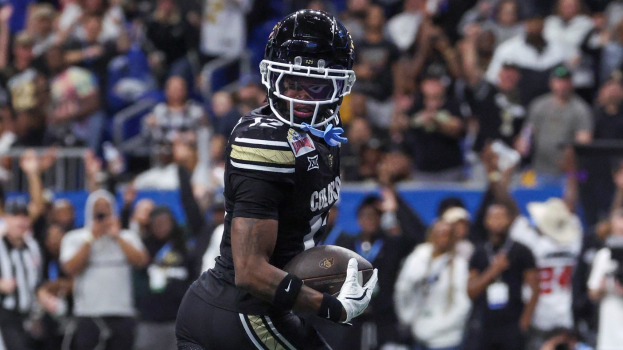Dec 28, 2024; San Antonio, TX, USA; Colorado Buffaloes wide receiver Travis Hunter (12) runs with the ball and scores a touchdown during the third quarter against the Brigham Young Cougars at Alamodome.