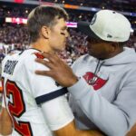 Tampa Bay Buccaneers quarterback Tom Brady (12) celebrates with offensive coordinator Byron Leftwich after defeating the Arizona Cardinals in overtime at State Farm Stadium.