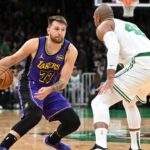 Los Angeles Lakers guard Luka Doncic (77) dribbles the ball against Boston Celtics center Al Horford (42) during the first quarter at the TD Garden