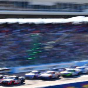 Mar 9, 2025; Avondale, Arizona, USA; NASCAR Cup Series driver Denny Hamlin (11) and driver Christopher Bell (20) lead the field during the restart of the Shriners Children’s 500 at Phoenix Raceway. Mandatory Credit: Gary A. Vasquez-Imagn Images