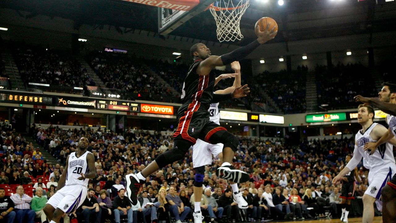 Miami Heat guard Dwyane Wade (3) makes an acrobatic layup against the Sacramento Kings in the second half at Arco Arena. The Heat defeated the Kings 115-102.